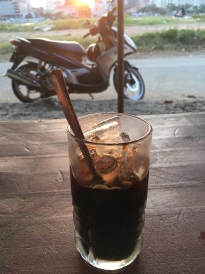 an iced Vietnamese coffee by the side of the road